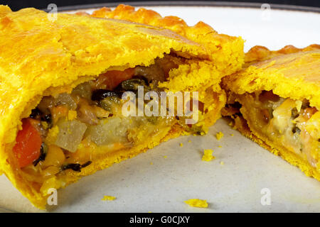 Gefüllt mit Cheddar-Käse, Zwiebel, Karotte, Schwede, Kartoffeln und Süßkartoffeln in Teig halbieren vegetarische pastös. Stockfoto