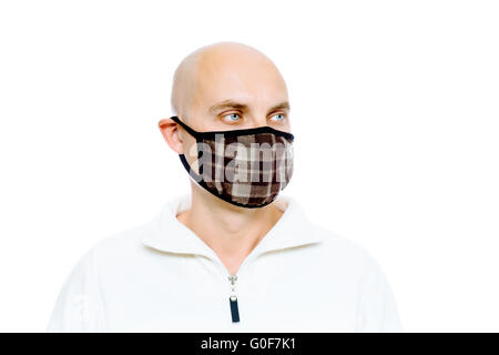 Kahlen, Mann in einem weißen Jacke und Maske. Studio. isoliert Stockfoto