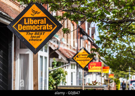 Reihe der Reihenhäuser Anzeigen von politischen Parteien pole Zeichen in Wahlen, Watford, Hertfordshire, England, UK. Stockfoto