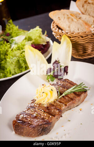 Gegrilltes Rindersteak, garniert mit Butter und Rosmarin Stockfoto