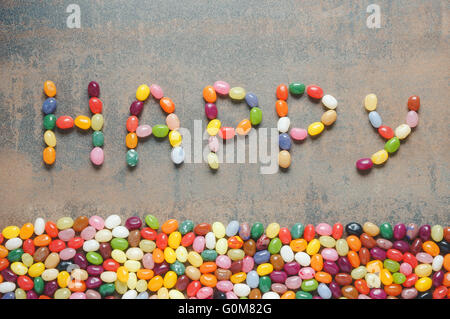 Glücklich mit Gummibärchen, dunklen Hintergrund mit bunten Rand geschriebene Wort Stockfoto