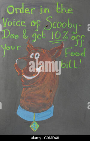 ScoobyDoo gezeichnet auf einer Tafel Werbung "In der Stimme von Scooby-Doo und erhalten Sie 10 % Rabatt auf Ihr Essen Bill bestellen" Stockfoto