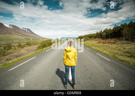 Schöne Frau, eine schöne Straße, mitten in der Natur zu betrachten Stockfoto