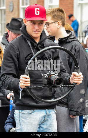 Der Mensch nutzt eine Rad-Klammer-Rig um eine SLR-Kamera zu stabilisieren, während der Dreharbeiten Video. Stockfoto