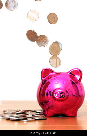 Sparschwein mit Geld hinein gießen sparen Stockfoto