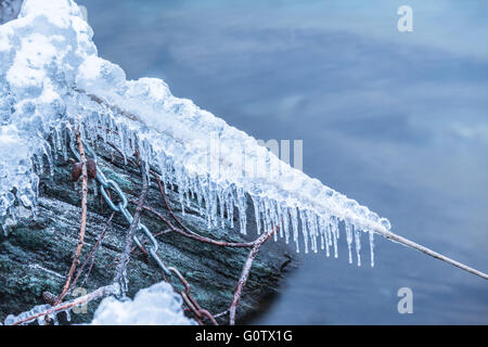 Nahaufnahme von Eis, Schnee und Frost gefrorenen Seil und Stahlkette auf Wasser. Konzept der Kälte, Winter, Frost, Frustration, Stockfoto