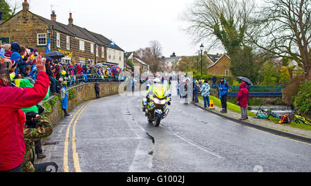 Menschenmengen säumen die Straße in Great Ayton, wie das Motorrad die Blei-Fahrer in Phase 3 des Tour de Yorkshire, 1. Mai 2016 vorausgeht Stockfoto