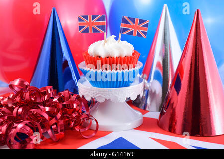 Holiday Party Cupcakes mit roten, weißen und blauen Partyhüte, britische Flaggen und Luftballons. Stockfoto