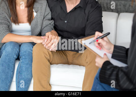 Junges Paar mit einem Problem zu konsultieren, ein Psychologe Closeup, Theraphy, jede andere Hand hält Stockfoto