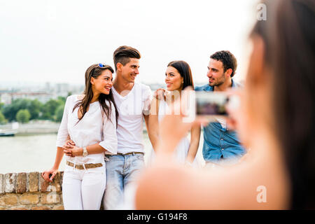 Junge und schöne Paare fotografieren mit smartphone Stockfoto