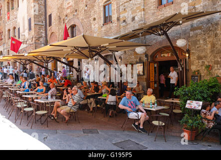 Ein Restaurant auf dem Hauptplatz von San Gimignano genannt Piazza Cisterna, in der Toskana, Italien. Stockfoto