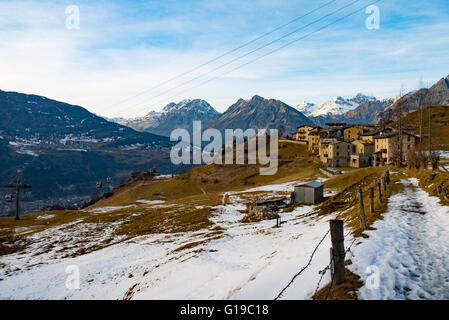 Berglandschaft mit Seilbahn, Schnee und typische Häuser Stockfoto