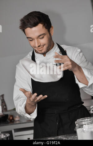 Koch Kochen Pizza in der Küche mit Händen Stockfoto