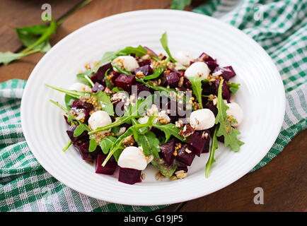 Salat von gebackenen Rüben, Rucola, Käse und Nüssen Stockfoto