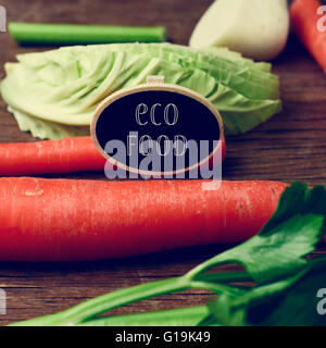 Nahaufnahme von einem schwarzen Schild mit dem Text Eco Essen platziert auf einem Stapel von einigen verschiedenen rohes Gemüse wie Karotten, Pastinaken Stockfoto