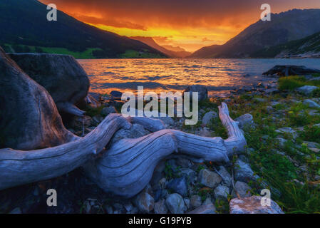 Schöne Aussicht auf den See Resia. Dramatischer Himmel und farbenprächtigen Sonnenuntergang. Alpen, Italien, Europa. Stockfoto