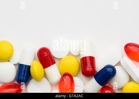 Eine Vielzahl von schmerzstillenden Medikamenten in Form von Pillen und Tabletten auf einem isolierten weißen Hintergrund an der Unterseite des Rahmens. Stockfoto