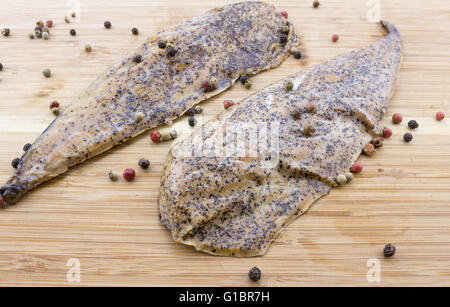 Zwei gespickt, Senf verkrustete geräucherte Makrele auf Holz Schneidebrett Stockfoto
