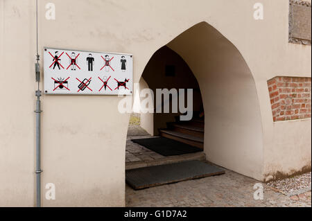 Schild auf Pfarrkirche Wand außen in Kazimierz Dolny, Polen, Europa, Symbole Warnung verboten verboten. Stockfoto