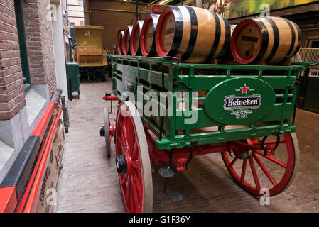 Ein Wagen mit einigen Heineken Fässer befindet sich durch die Ställe in der Heineken-Museum in Amsterdam, Holland, Niederlande. Stockfoto