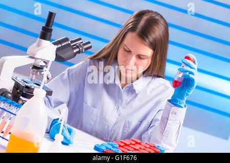 -MODELL VERÖFFENTLICHT. Weibliche Laborantin Notizen im Labor. Stockfoto