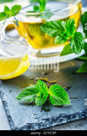 Tee. Pfefferminztee. Kräutertee. Minze Blatt. Minze. Tee in eine Glasschale, Minze Blätter, getrocknete Tee, in Scheiben geschnitten Kalk. Kräuter Tee und Minze l Stockfoto