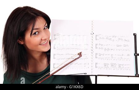 Mädchen und Notebook für Musiknoten Stockfoto