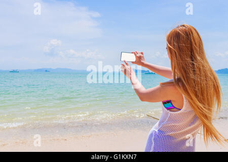 Glücklich attraktive Blondine im Bikini Fotografieren selbst an einem schönen sonnigen Strand Stockfoto