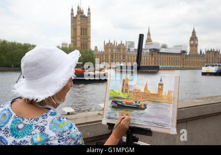 Ein Künstler malt die Houses of Parliament und Big Ben aus über den Fluss Themse Stockfoto