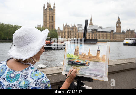 Ein Künstler malt die Houses of Parliament und Big Ben aus über den Fluss Themse Stockfoto