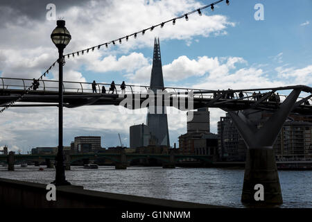 Silhouette von Shard und Menschen überqueren die Millennium Bridge London UK Stockfoto