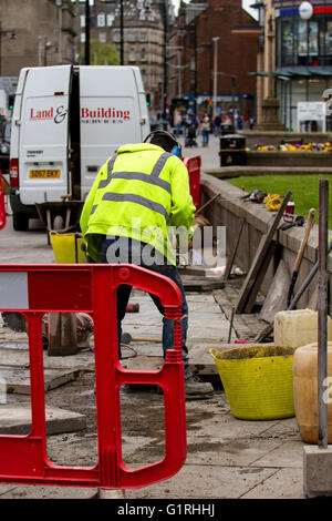 Arbeiter aus den hoch-und Tiefbau-Unternehmen "Land & Gebäudetechnik" schneiden und Verlegung von Betonplatten in Dundee, Großbritannien Stockfoto