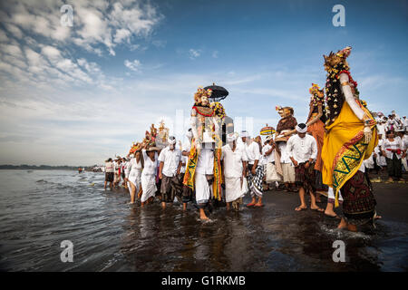 Balinesische Strand Zeremonie wo Indonesier Angebote und Geschenke für die Götter zum Meer während der Melasti Zeremonie tragen Stockfoto