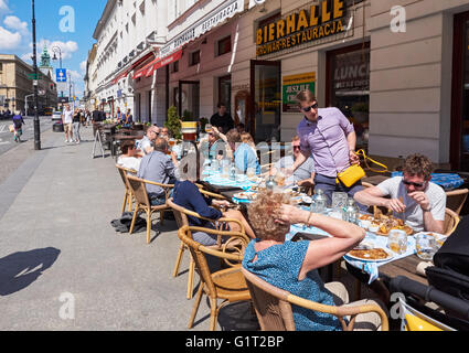 Menschen sitzen vor Restaurant auf Nowy Swiat-Straße in Warschau, Polen Stockfoto