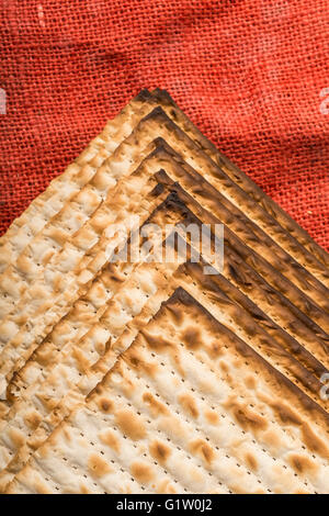 Matza - jüdischen Pessach Brot auf roten Sackleinen Stockfoto