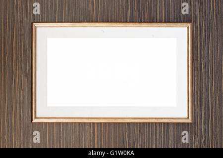 leere goldene Bilderrahmen auf die Holzwand Stockfoto