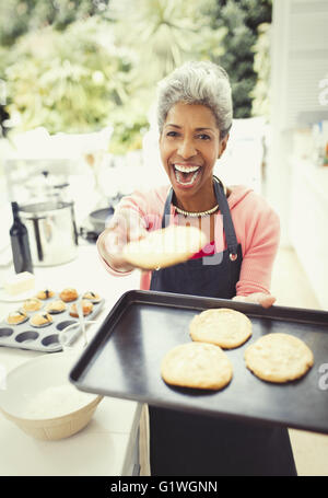 Porträt begeistert Reife Frau backen Kekse in Küche Stockfoto
