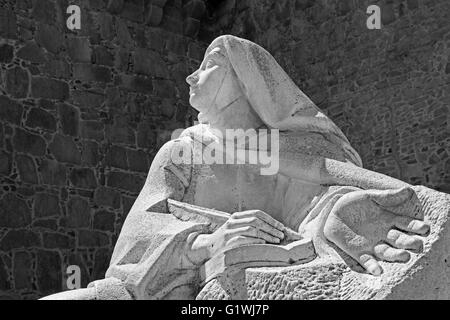 AVILA, Spanien, 18. April 2016: Die Statue des St. Theresia von Avila hinter der Stadtmauer des spanischen Bildhauers Juan L. Vassalo Stockfoto