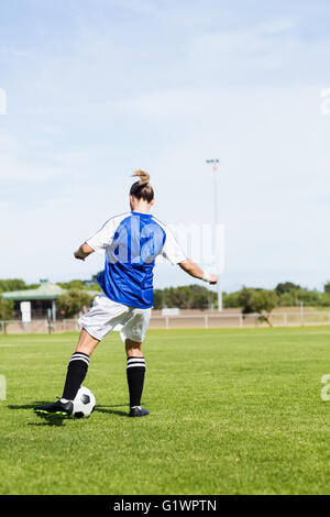 Rückansicht des weiblichen Fußballspieler üben Fußball Stockfoto