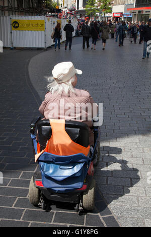 Reisen Senioren, Rentner, Behinderte Person mit Powered Mobility Scooter unterwegs in Liverpool, Merseyside, UK Stockfoto