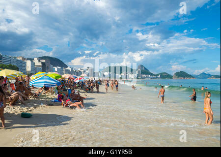 RIO DE JANEIRO - 27. Februar 2016: Eine steigende Flut bringt Wellen näher an Beachgoers genießen einen Nachmittag am Strand der Copacabana. Stockfoto