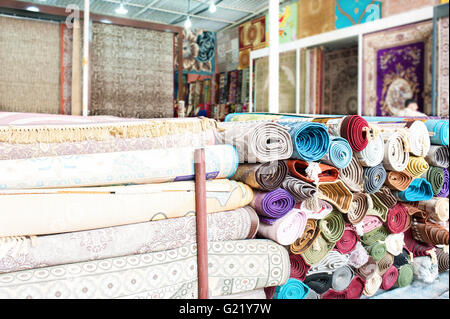 Viele bunte Teppiche zum Verkauf im Laden. Stockfoto