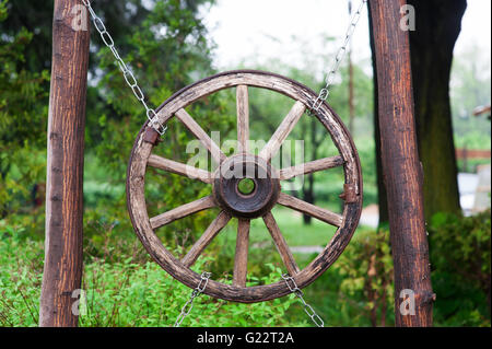 alte hölzerne Rad von einem Karren in Dorf Stockfoto