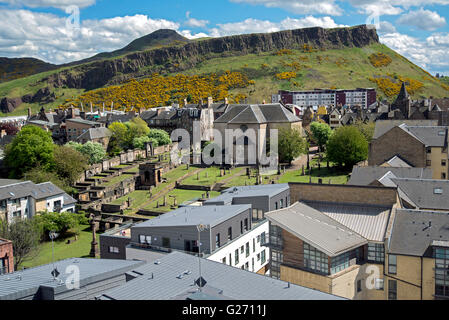 Blick auf das 17. Jahrhundert Canongate Kirk in Richtung Salisbury Crags und Arthurs Seat in Edinburgh. Stockfoto