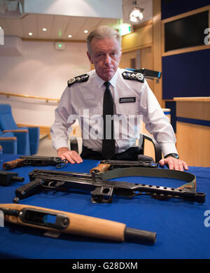 Metropolitan Police Commissioner Sir Bernard Hogan-Howe im New Scotland Yard in London, mit einigen der Waffen Polizisten haben vor kurzem in der Stadt beschlagnahmt. Stockfoto