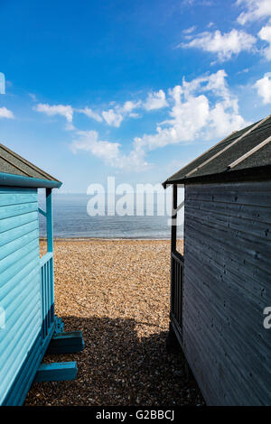 Zeigen Sie zwischen Strandhütten an der Themse-Mündung und Windpark am Horizont, Hampton, Herne Bay, Kent, UK an Stockfoto