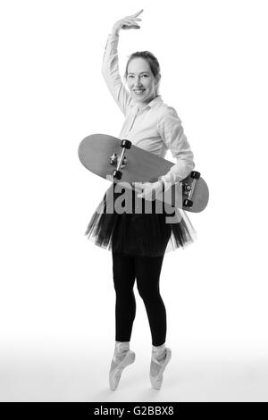 Voller Länge Studioaufnahme von einer Ballerina Geschäft Modell de Pointe eine Skateboard in der einen Hand festhalten. Stockfoto