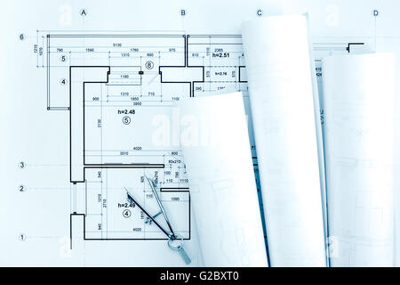 architektonische Blaupause rollt und plant mit dem Kompass auf Schreibtisch zeichnen Stockfoto