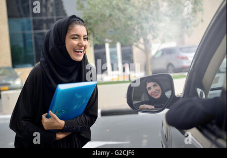 Emirati arabischen Geschäftsfrauen einsteigen in das Auto in Dubai, Vereinigte Arabische Emirate. Stockfoto