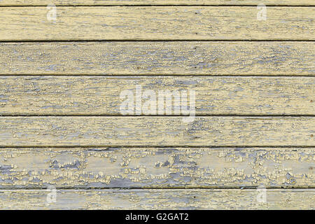 Bemalte alte klebrige gelbe Holzzaun Stockfoto